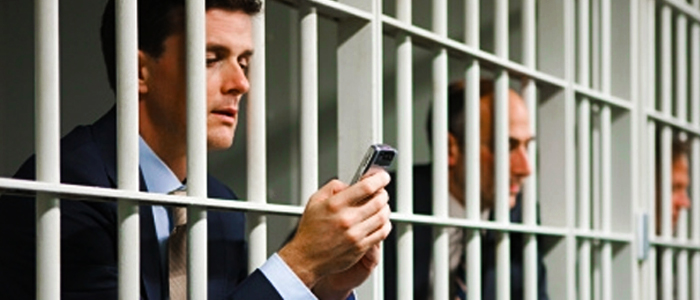 phone time savers - businessmen in jail with mobile phones
